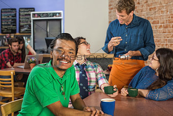 Smiling Man with Friends and Barista