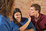 Man Kissing Annoyed Woman