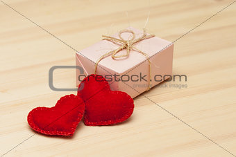 Pink gift box and two hearts