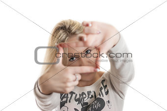 Young girl looking through her hands