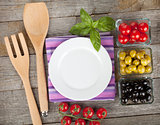 Empty plate on wooden with fruits and utensils
