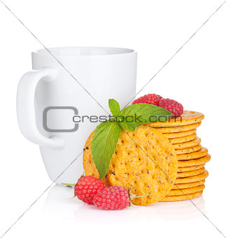 Stack of crackers with mint, berries and cup of drink