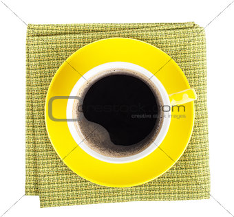 Yellow coffee cup over kitchen towel
