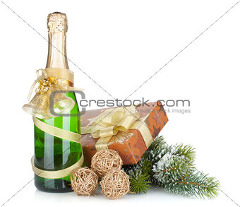 Champagne bottle, christmas gift and snowy firtree