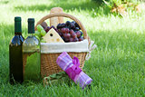 Outdoor picnic basket with wine on lawn