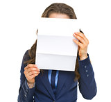 Business woman holding letter in front of face