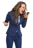 Angry business woman shouting in cell phone