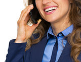 Closeup on happy business woman talking mobile phone