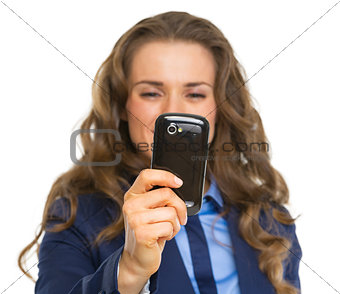 Closeup on business woman taking photo with cell phone