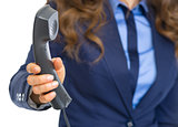 Closeup on business woman giving phone handset
