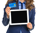 Closeup on business woman holding tablet pc blank screen and cre
