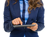 Closeup on business woman using tablet pc