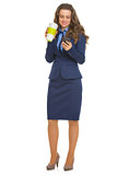 Full length portrait of happy business woman with cup of hot bev