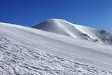 Ski slope and blue cloudless sky in nice winter day