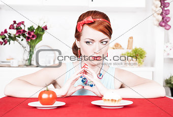 Woman choosing between healthy food and cake