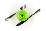 fork, knife, green apple on white dish