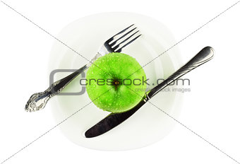 fork, knife, green apple on white dish