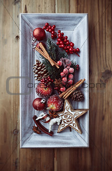 Rustic christmas decorations on a wooden tray