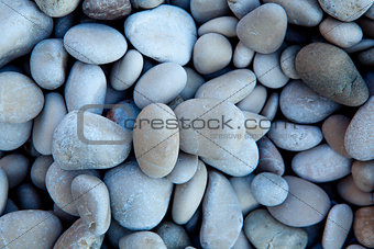 Naturally polished white rock pebbles background