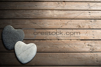 Stone Hearts on Wooden Boardwalk with Sand