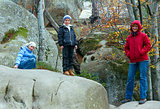 lofty stones in autumn forest and family