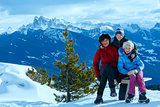 Family walking on winter mountain slope