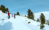Family plays at snowballs on winter mountain slope