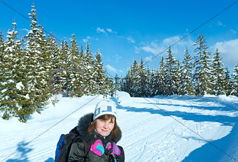 Woman and winter mountain fir forest landscape