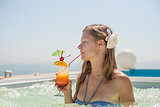 Woman drinking tropical cocktail