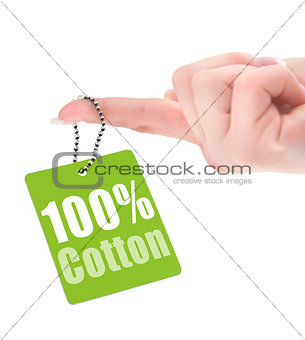 female hand showing hundred percent cotton tag