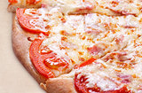 Pizza with ham, tomato and cheese
