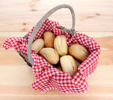 Rustic picnic basket of fresh bread rolls