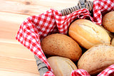 Fresh bread rolls in a rustic picnic basket