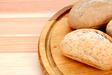 Closeup of fresh bread rolls on a wooden board