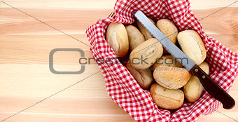 Basket of petit pain and a bread knife 