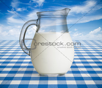 Milk jug on blue tablecloth