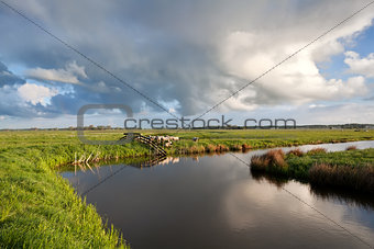 cloudscape over Dutch farmland with grazing sheep