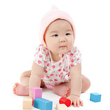 Asian baby girl playing wood blocks 