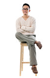 Asian male sitting on a chair