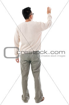 Rear view Asian man touching on transparent virtual screen