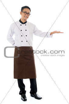 Asian male chef hand showing blank space