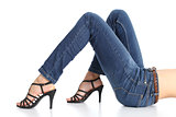 Woman legs with jeans and sandal heels isolated