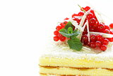 sponge cake with white chocolate, decorated with red currant
