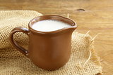 ceramic brown  jug full of milk