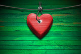 Red Wooden Heart on Green Wood Background