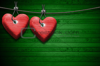 Red Wooden Hearts on Green Wood Background