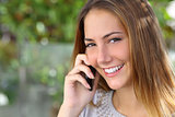 Beautiful woman with a perfect white smile talking on the mobile phone
