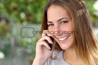 Beautiful woman with a perfect white smile talking on the mobile phone