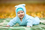 Happy baby boy in autumn park