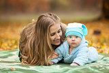 Young woman with baby in autumn park
